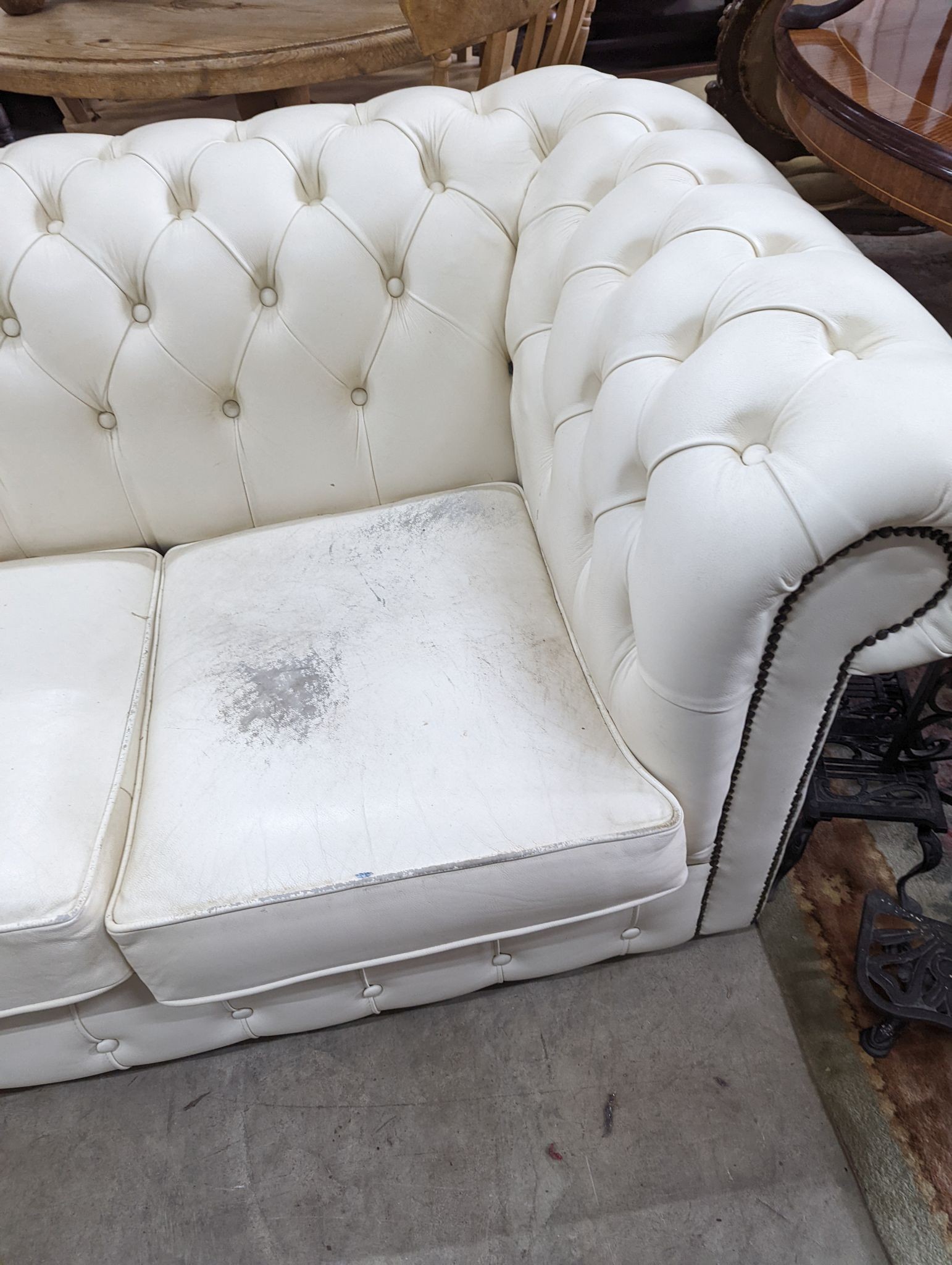 A Victorian style buttoned white leather Chesterfield settee, length 190cm, depth 86cm, height 72cm